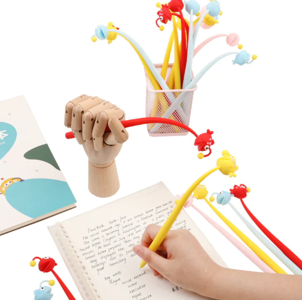 Anglerfish Wiggle Gel Pen in assorted colors shown writing on notebook with smooth, opaque gel ink.