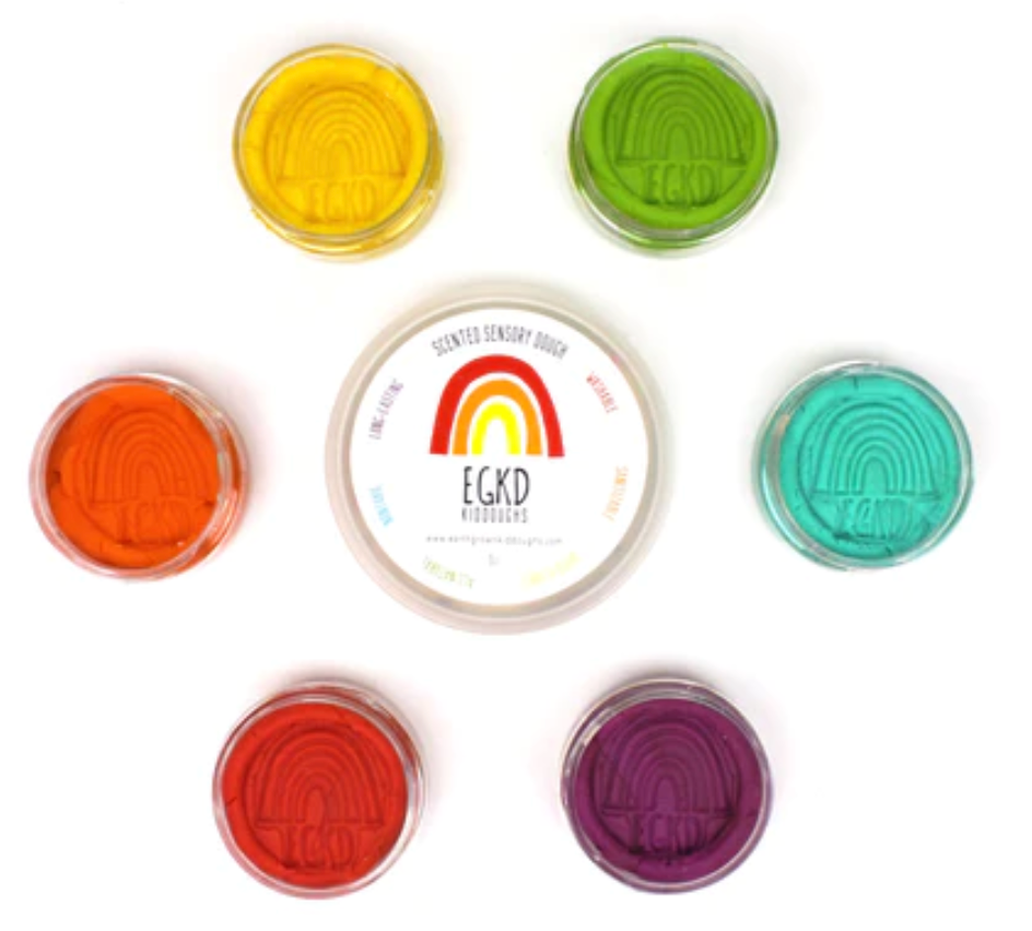 KidDough Mini Rainbow | Bright colorful non-toxic doughs in clear containers arranged in a circle around a white lid.