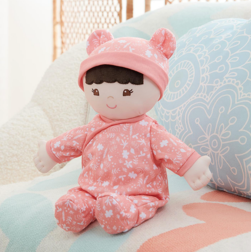 Recycled Baby Doll | Hibiscus soft plush doll in floral pink outfit with embroidered face, made from 100% recycled materials.