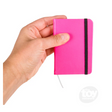 Hand holding a bright pink Neon Pocket Notebook with elastic band, perfect for notes on the go, 3 x 4 inches.