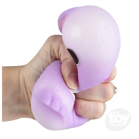 Hand squeezing a purple silicone Squish & Stretch Bunny stress relief toy for fidgeting and sensory play.