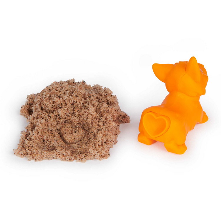 Kinetic Sand Doggie Dig with orange dog tool and textured beach sand shaped with heart stamp imprint.