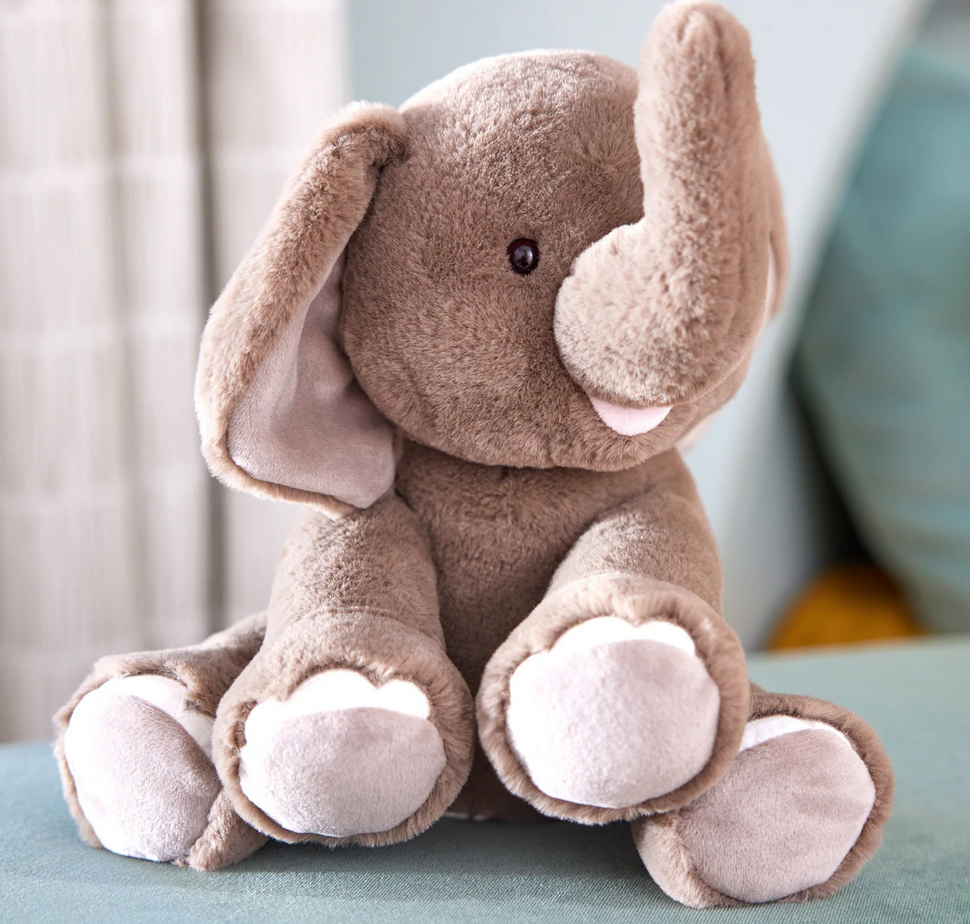 Elephant Chai plush toy sitting upright with soft gray fur and a friendly, smiling face.
