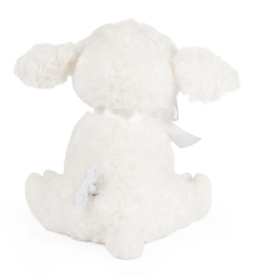 Musical Lamb Lena sitting with white plush fur, satin ribbon, and wind-up key for Brahms’ Lullaby music.