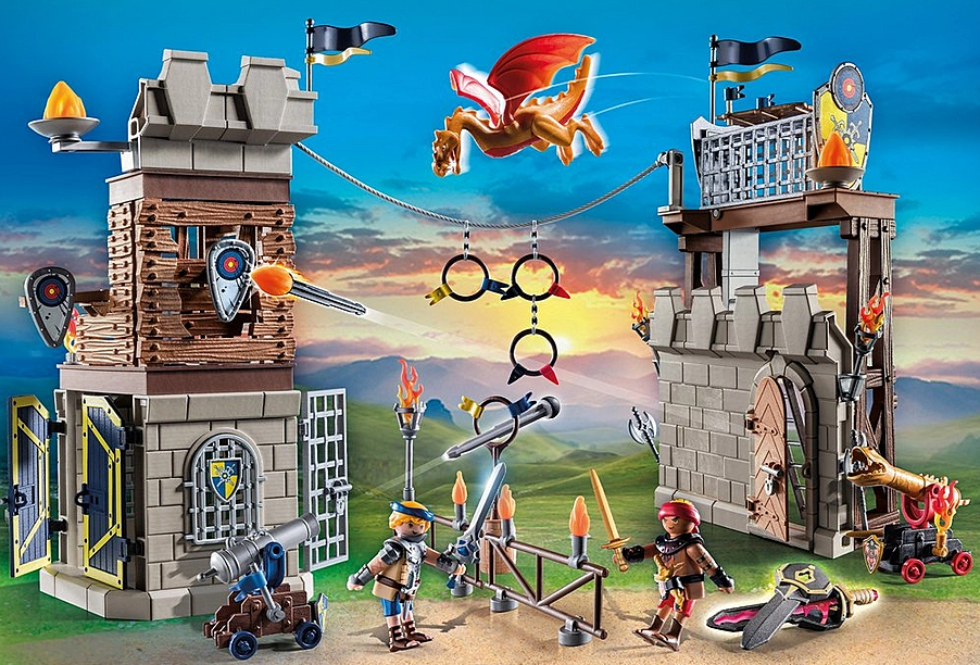Novelmore | Tournament Arena playset with knights, cannons, targets, trap doors, and a flying dragon at sunset background.