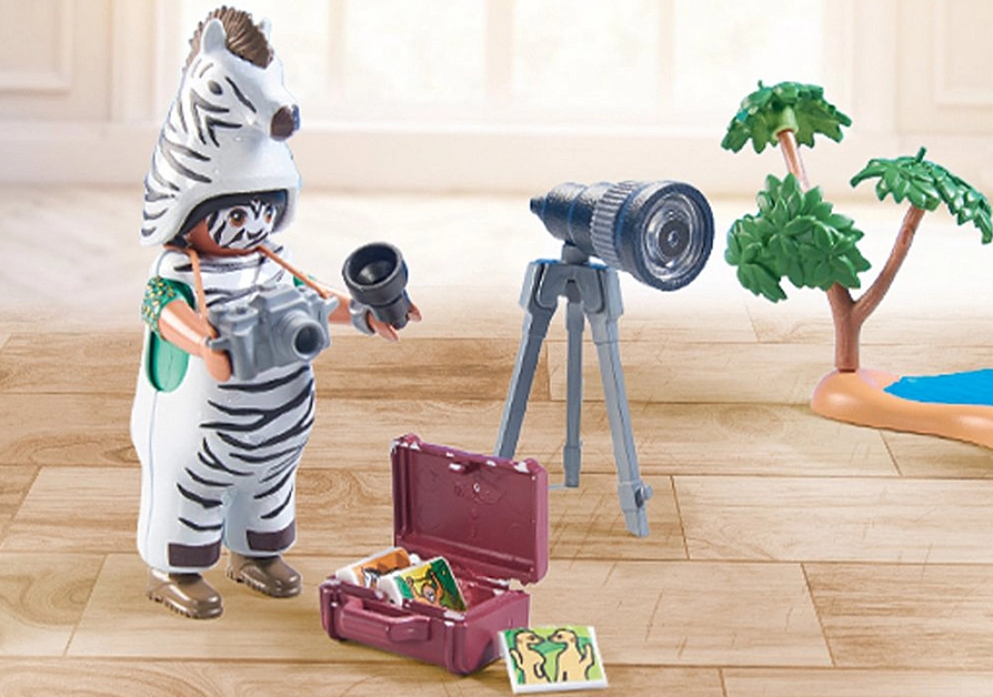 Wiltopia Animal Photographer playset with zebra costume figure, camera, tripod, and nature accessories for safari fun.