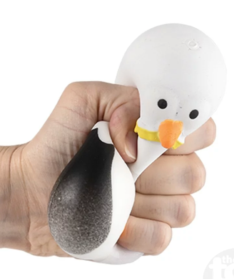 Hand squeezing the Squish & Stretch Seagull fidget toy designed for stress relief and sensory play.
