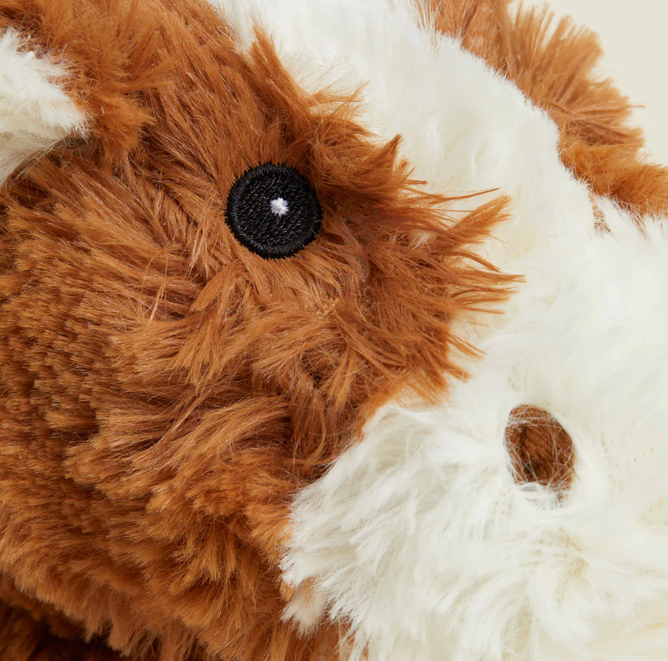 Close-up of Warmies | Horse plush with soft brown and white fur and detailed embroidered eye.