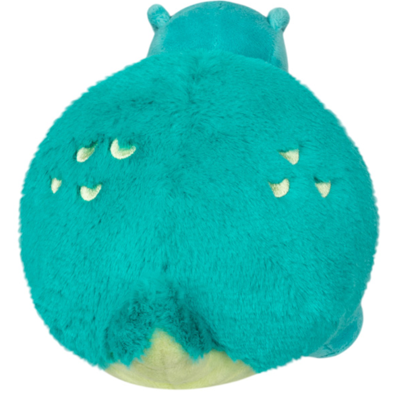 T-Rex Snackers plush toy showing a soft, teal, furry back with small yellow claw markings and tiny ears.