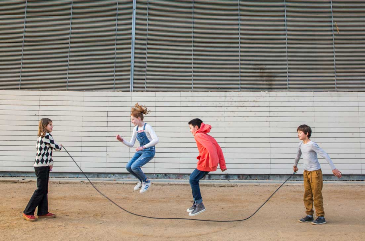 Children playing with the Jump Rope | Playground Blue & Yellow outdoor, featuring a long cotton rope with wooden handles.
