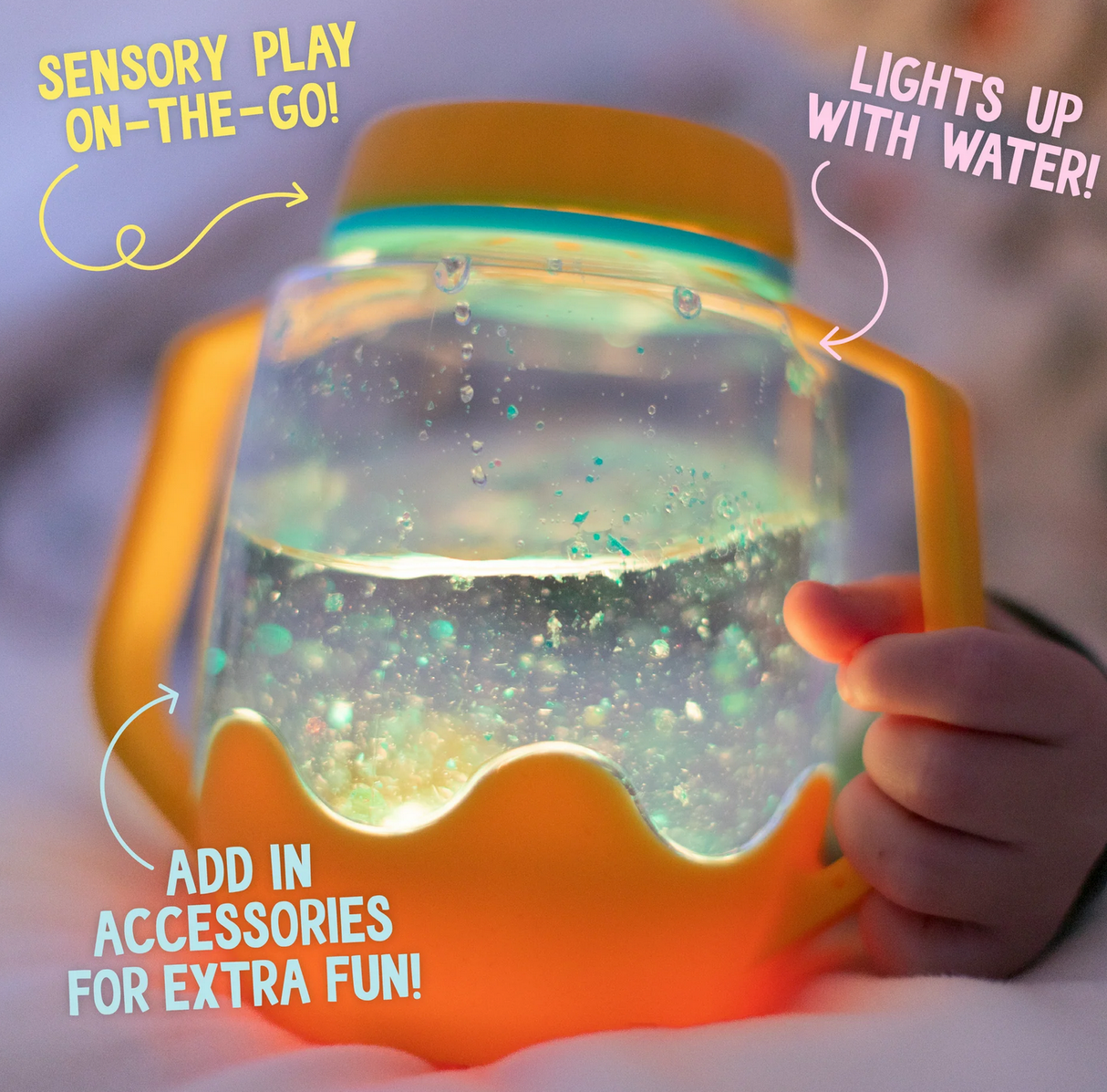 Sensory Jar | Orange glowing with water, held by child, featuring spill-proof lid and handle for sensory play on-the-go.
