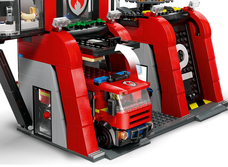 Close-up of LEGO City Fire Station with Fire Truck showing fire engine exiting the red garage doors.
