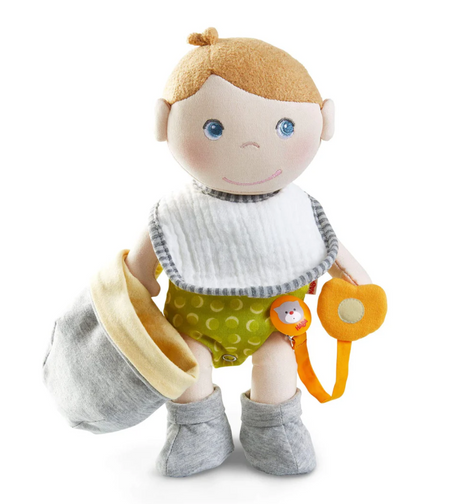 Maxime Baby Doll with embroidered face, removable bib, soft clothes, and magnetic pacifier with ribbon for nurturing play.