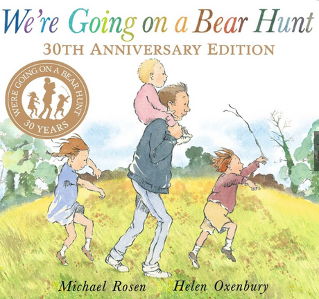 We're Going on a Bear Hunt 30th Anniversary edition cover with a father and children exploring outdoors together.