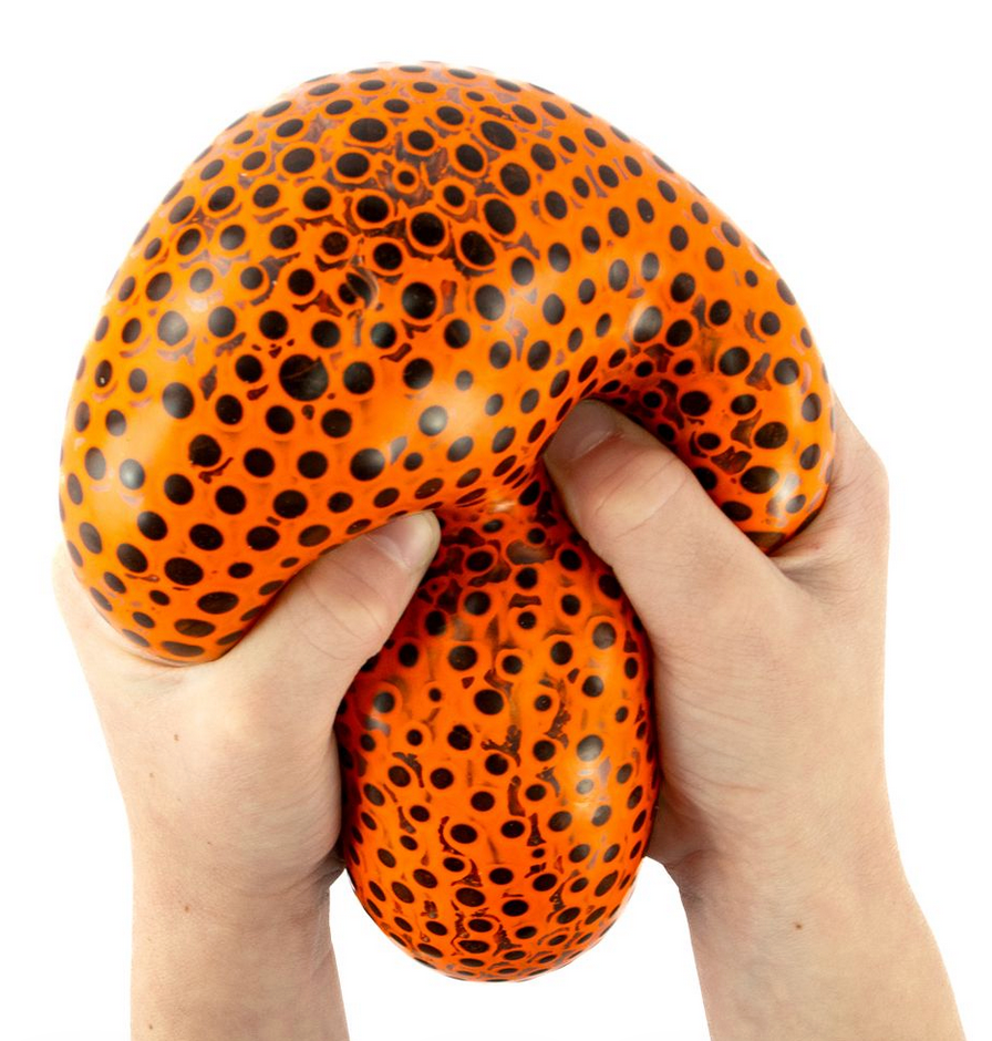 Hands squeezing an orange and black dotted Beads Alive Giant Ball for sensory stress relief and fun.