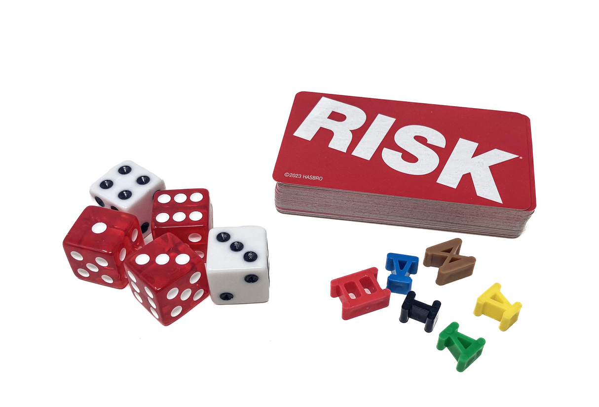 Risk 1980's Edition showing game cards, colored plastic Roman numeral armies, and red and white dice on white background.