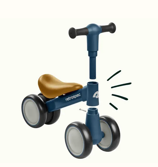 Cricket 2 Baby Walker Balance Bike Rainforest shown partially assembled with blue frame and brown seat for toddlers.