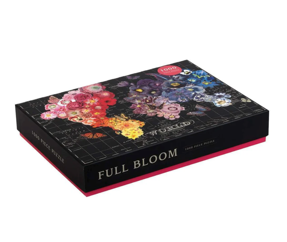 1000pc World Full Bloom Puzzle box featuring colorful floral and butterfly collage over a black world map background.
