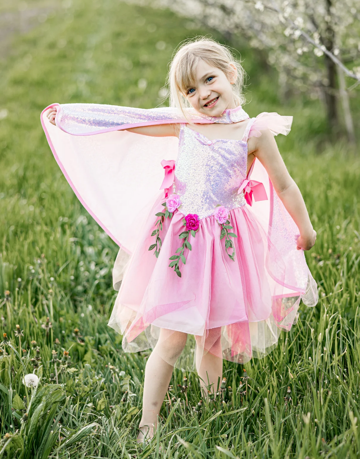 Pink Sequins Fairy Tunic | Size 3-4 worn by a smiling girl outdoors with floral and sequin details on the dress.