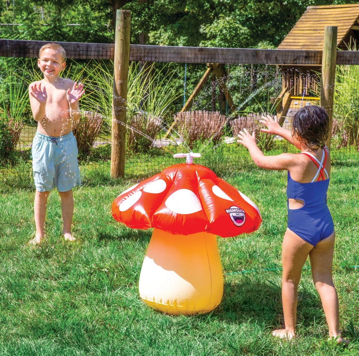 Kids playing with the Mini Mushroom Sprinkler in a sunny backyard, water spraying in 360-degree motion to cool off.