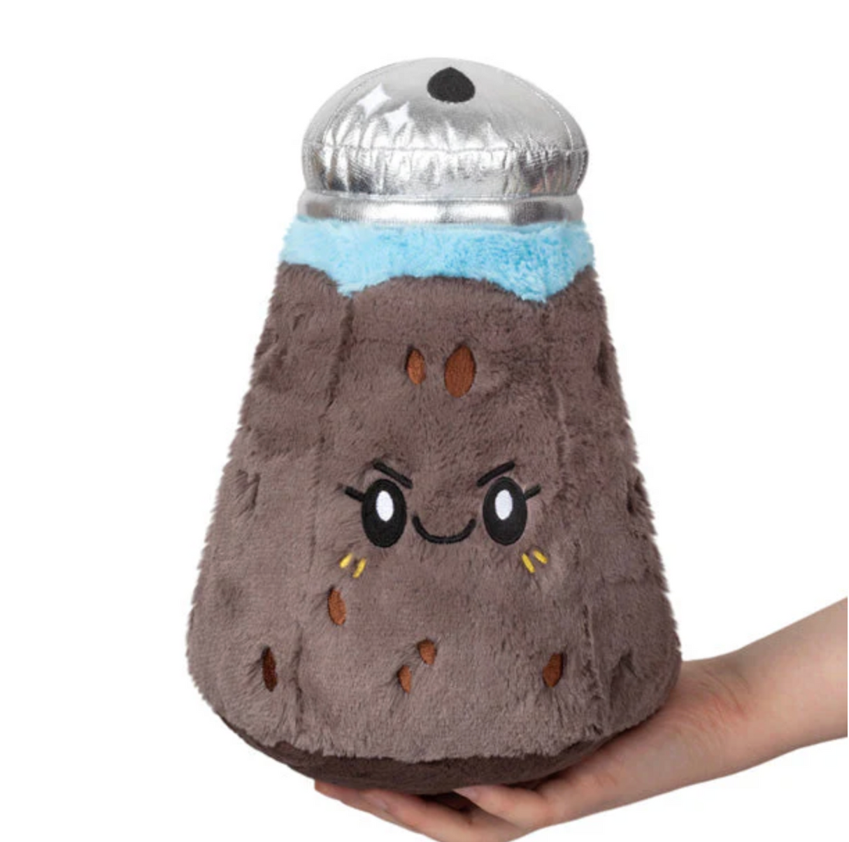 Soft plush toy shaped like a pepper shaker with a smiling face, called Pepper Mini, held in a hand.