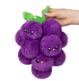 Grapes Mini plush toy with smiling purple grape characters and green leaves, held by a hand, soft and friendly design.
