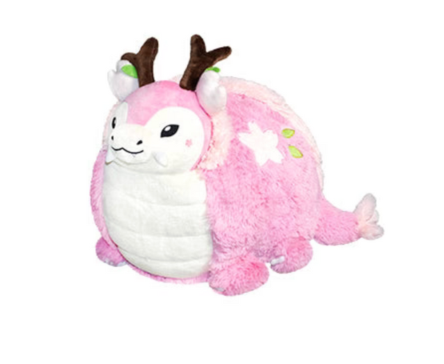 Sakura Dragon plush with pink floral design, antlers, and friendly face, perfect for all ages and cozy decor.