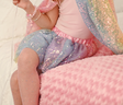 Sequins Skirt | Ombre Size 4-6 shown worn with pastel pink top and sparkling fishnet tights on pink textured blanket.