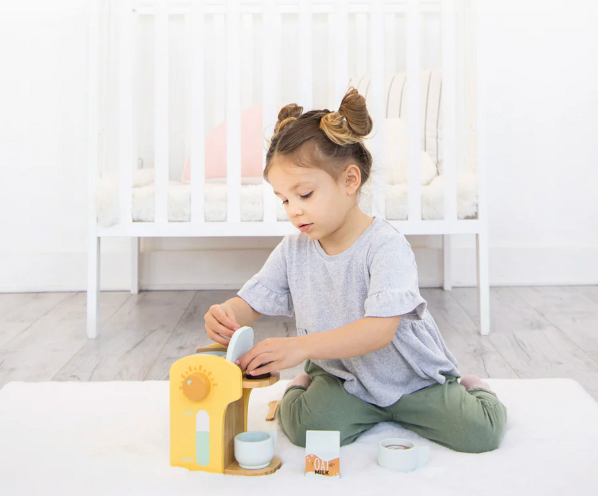 Child playing with Barista in Training Wooden Coffee Set, featuring coffee maker and accessories for imaginative play.