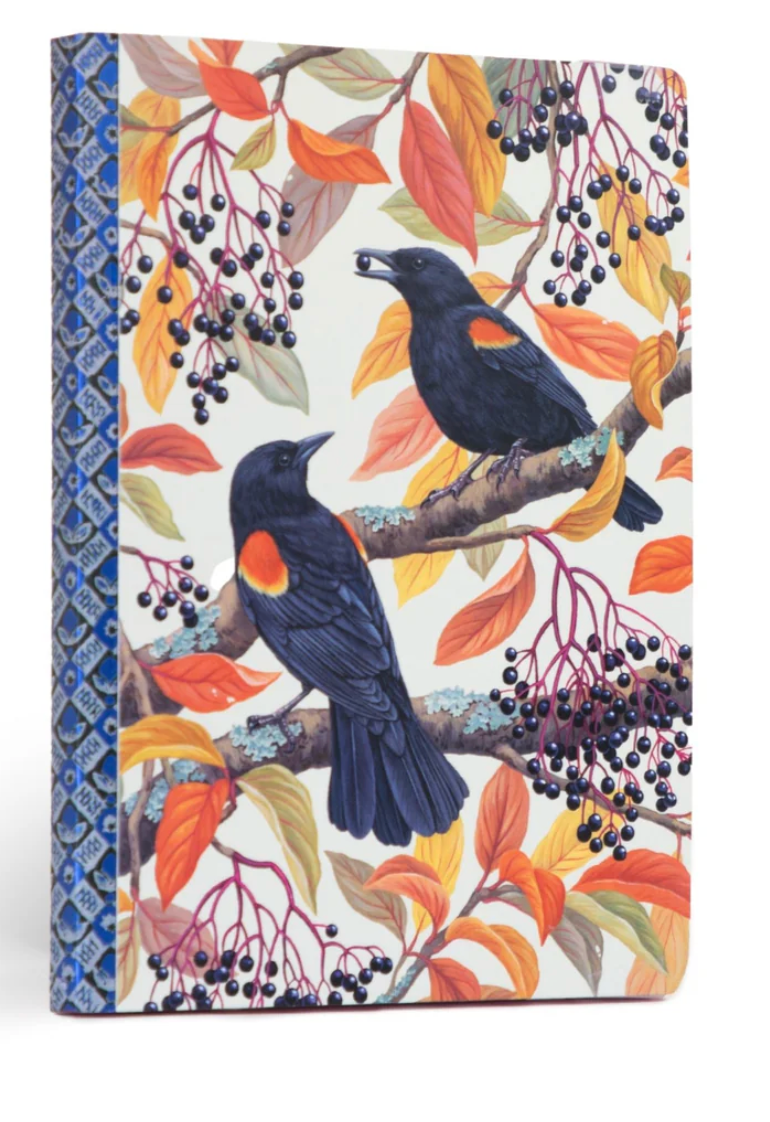 Autumn Blackbirds Journal with red-winged blackbird art, colorful autumn leaves, and decorative blue spine pattern.