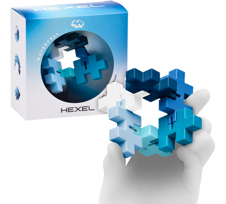 HEXEL fidget toy shown in hand with six connected Plus-Plus pieces in blue and white colors and packaging box.
