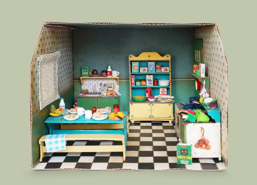 Sam & Julia | DIY Furniture Kit: Kitchen showing a 1:12 scale miniature wooden kitchen setup with stove, table, cupboards, and benches.