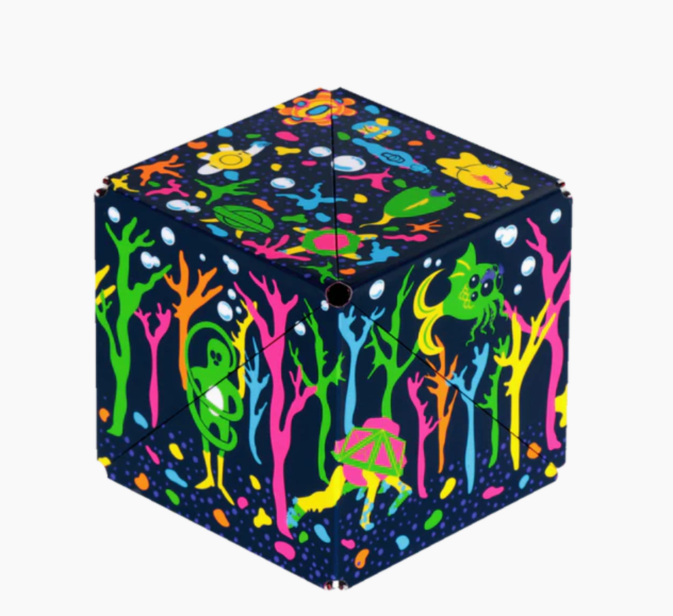 Shashibo | Glowquarium magnetic puzzle cube with vibrant underwater glow designs on a 2.4 inch recyclable cube.
