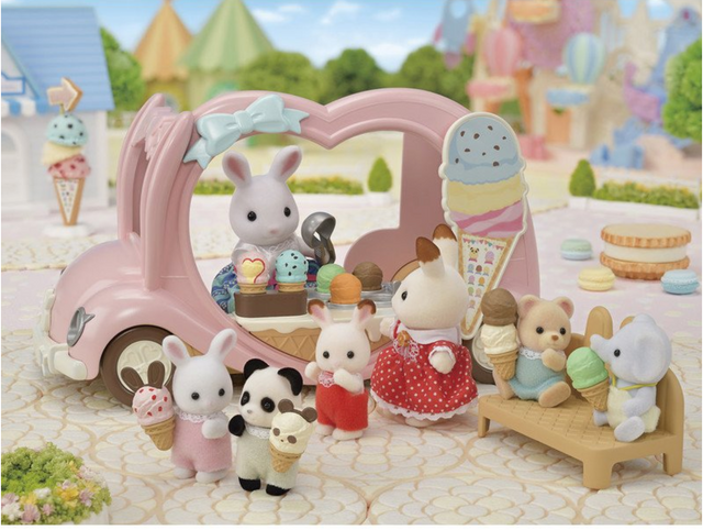 Pink Ice Cream Van toy with animal figures enjoying ice cream cones and accessories in a playful park setting.