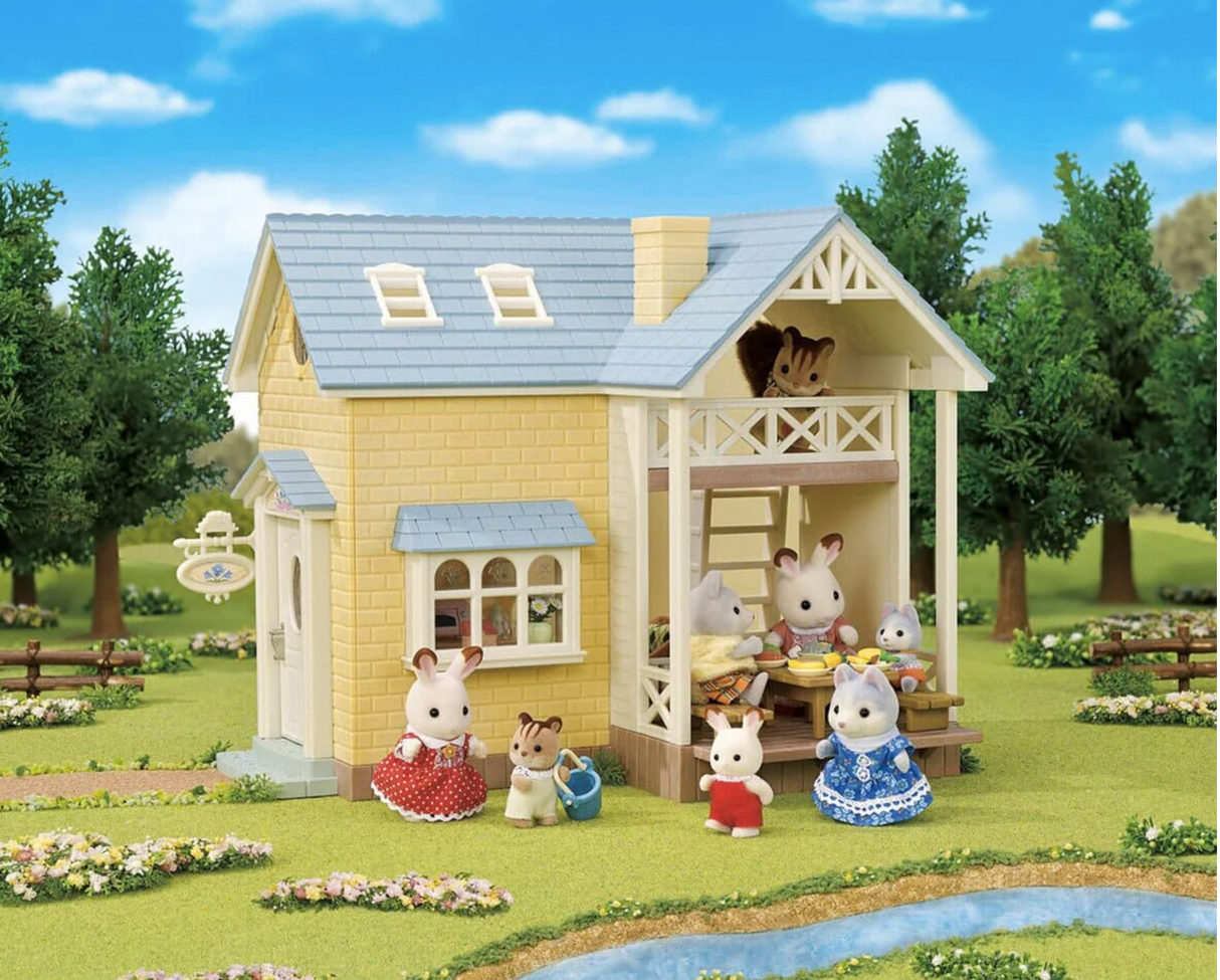 Bluebell Cottage Gift Set showing a charming cottage with furniture and snow rabbit figure in a garden setting.