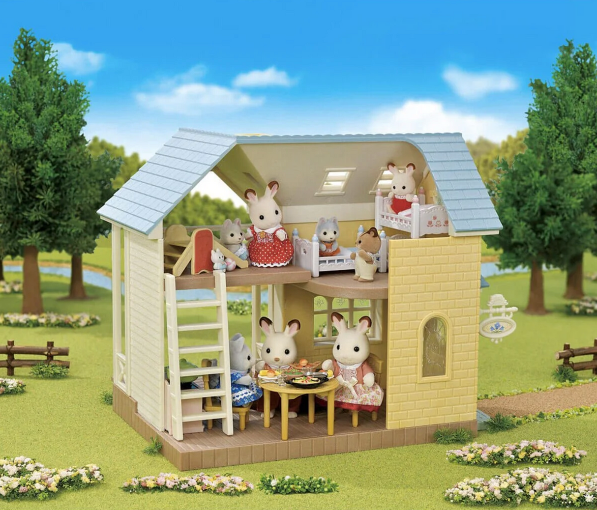 Bluebell Cottage Gift Set showing open floor plan with furniture, terrace, and Snow Rabbit figure in a charming outdoor scene.
