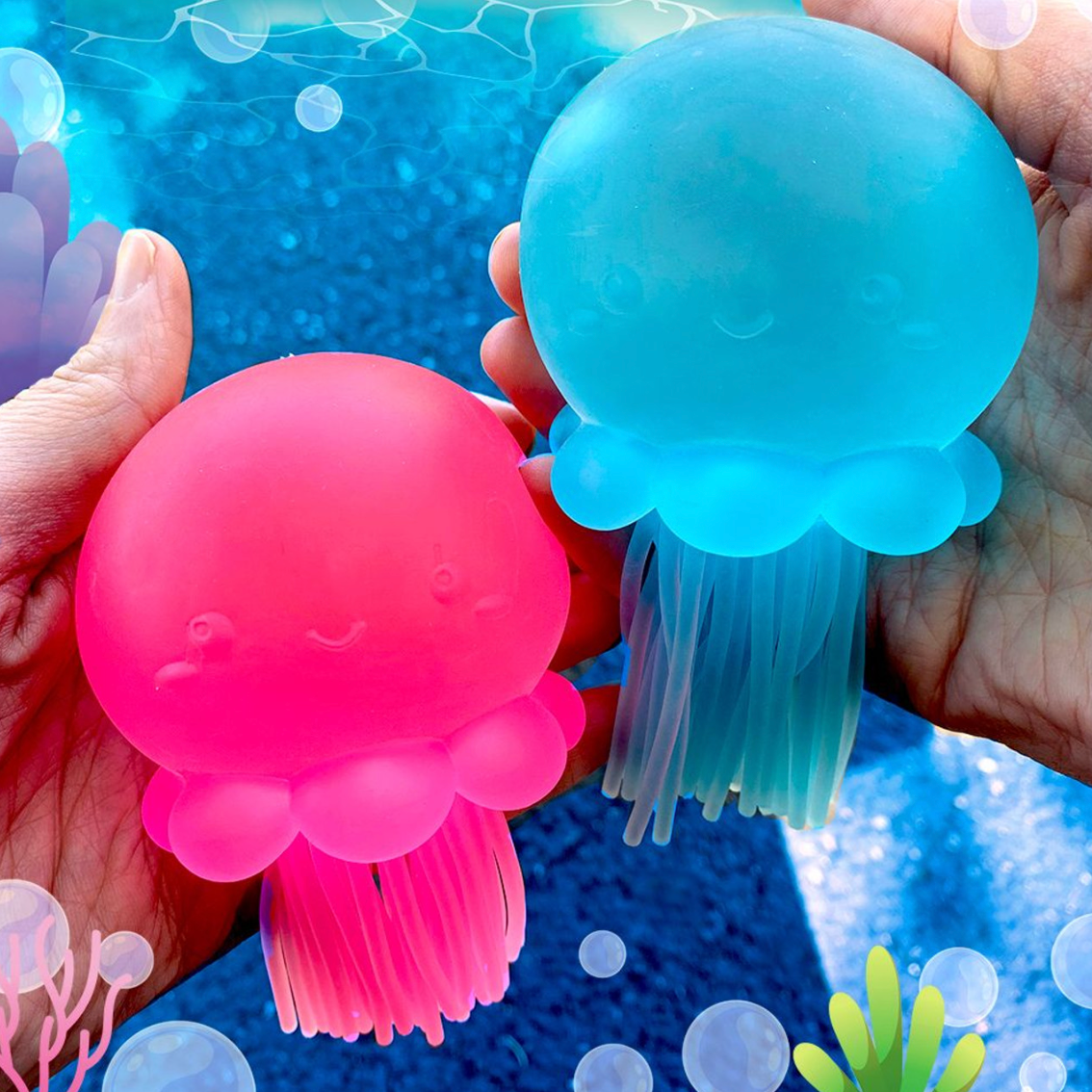Super Duper Sugar Squisher Jelly Fish in blue and pink held in hands with stretchy tentacles and smiling faces.