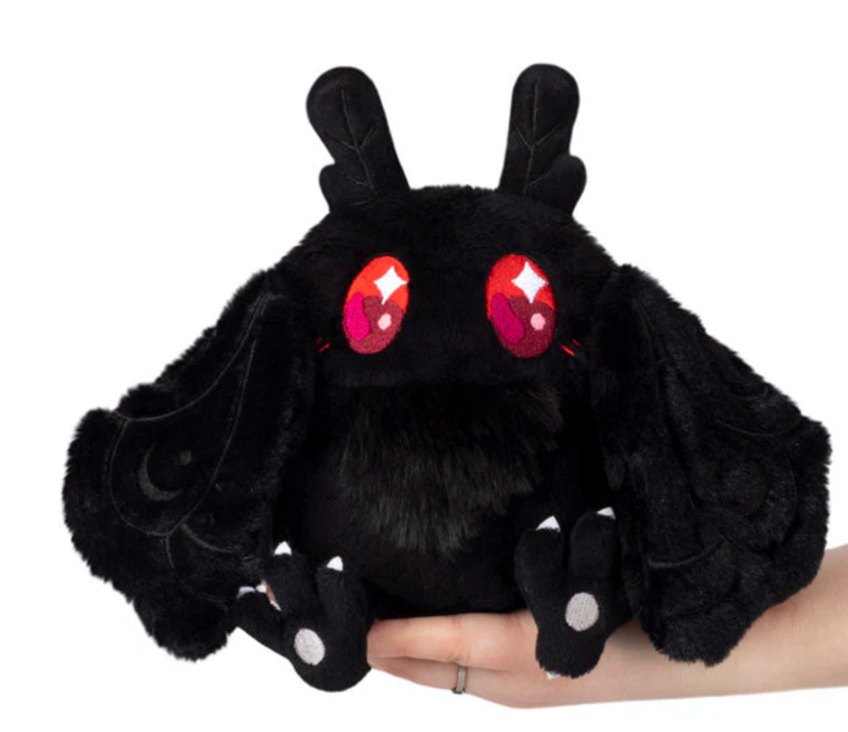 Baby Mothman Snackers plush toy with floppy wings and bright red eyes, perfect for all ages.