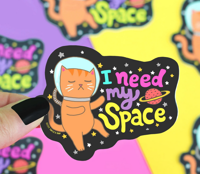I Need My Space Cat Sticker featuring an astronaut cat floating in space with colorful text and stars.