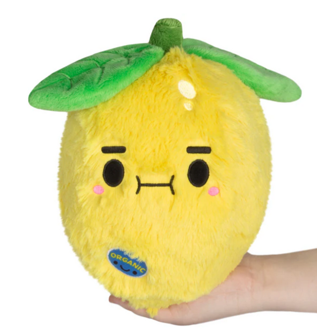 Lemon Mini plush toy with a cute face and green leaves, soft and perfect for all ages, held in hand.
