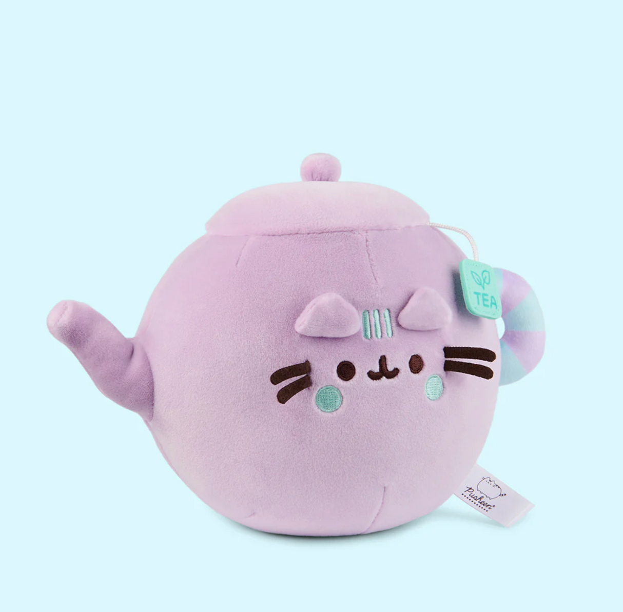 Pusheen Tea Pot plush in lilac with teal details, soft and squeezable with a cute teabag tag and cat face design.