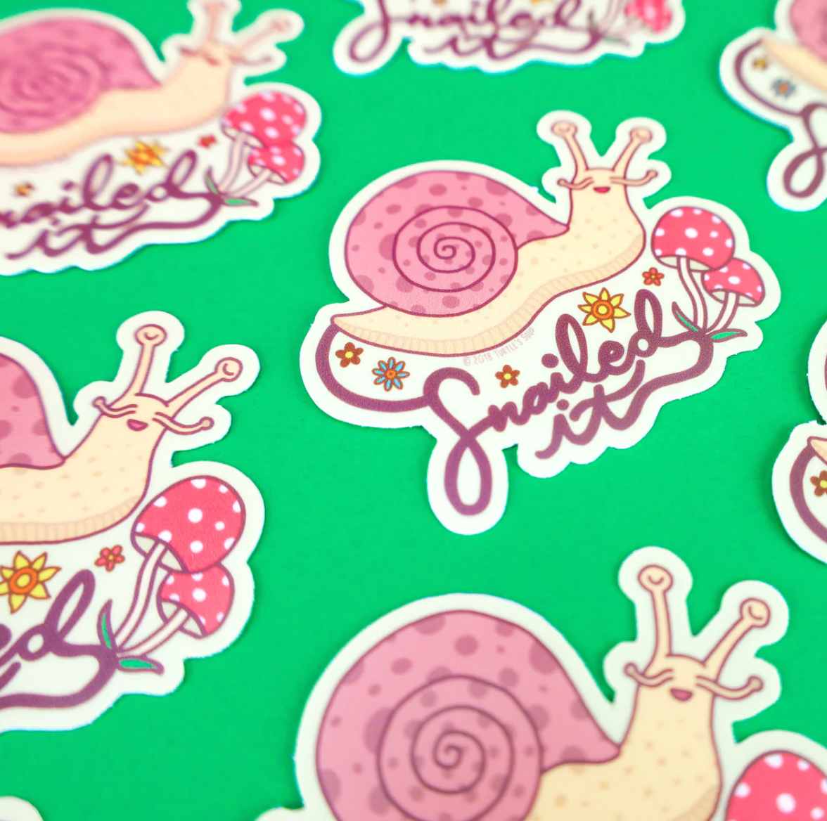Snailed It Sticker featuring a cute woodland snail with mushrooms and “snailed it” text on green background.