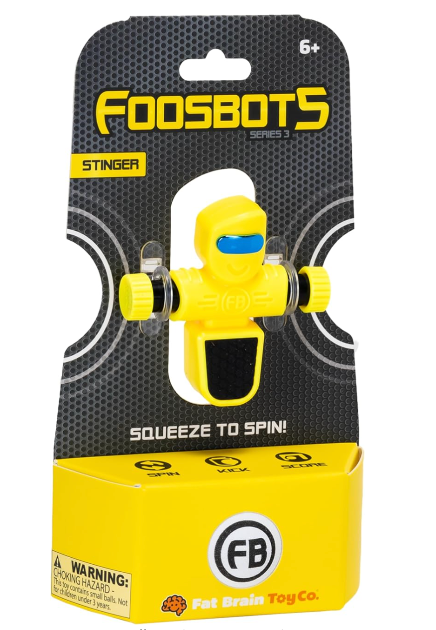 Foosbots Single squeeze-to-spin yellow foosball toy figure by Fat Brain Toy Co., suitable for ages 6 and up.