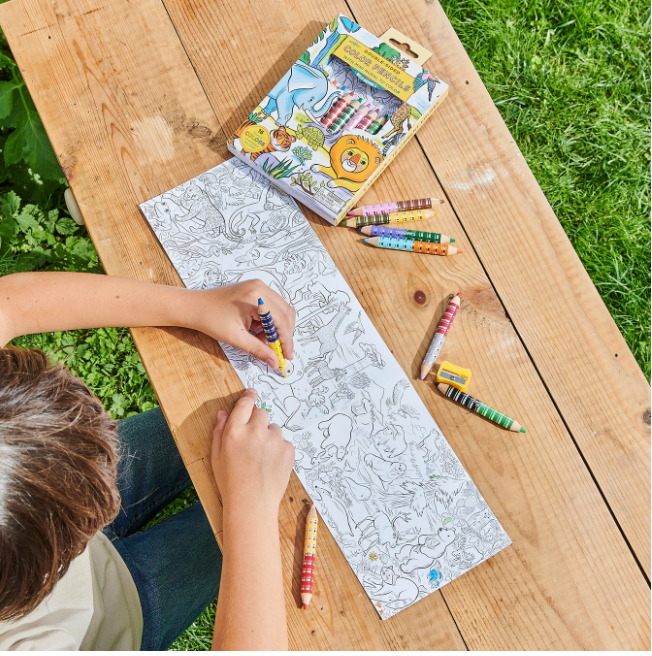 Child coloring a detailed fold-out mini mural of wild animals with Colored Pencils & Mini Mural | Wild Animals set outdoors.