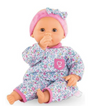 Calin Capucine baby doll with floral outfit, pink headband, brown sleeping eyes, and posable limbs for nurturing play.