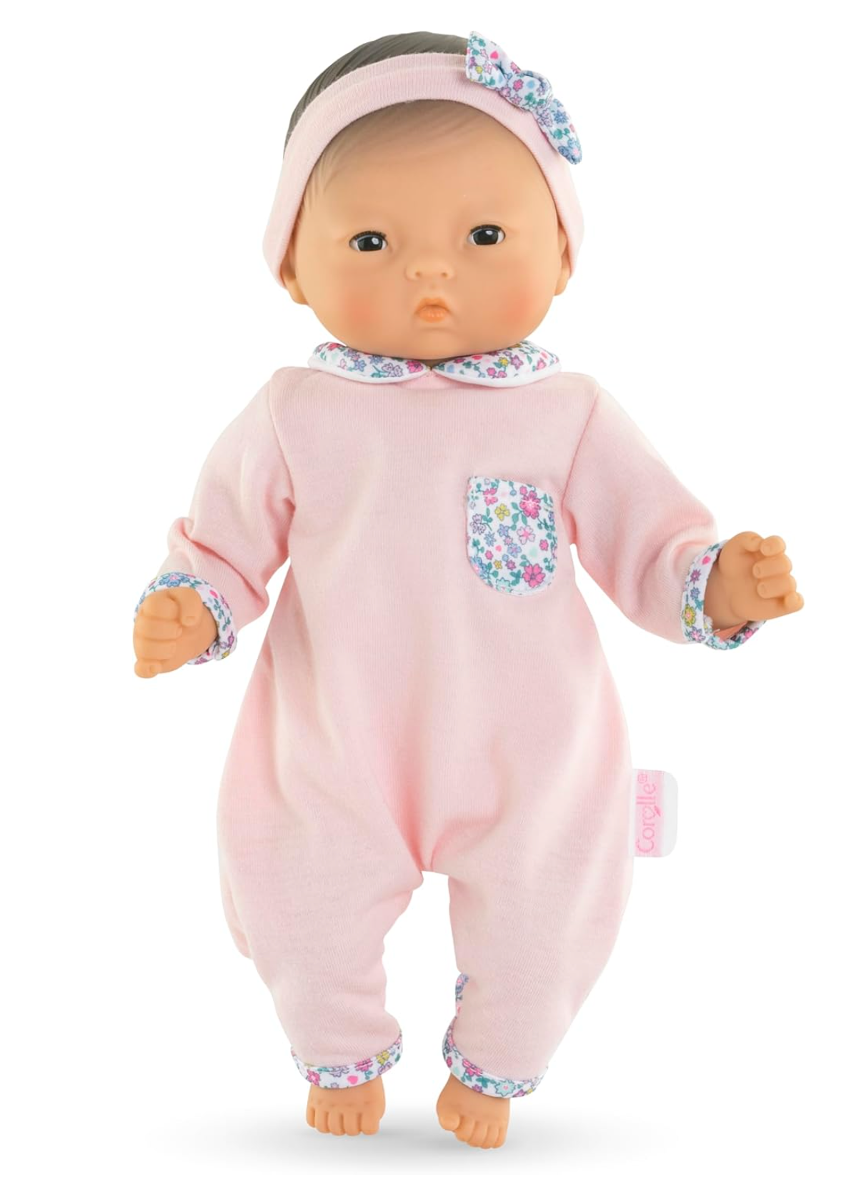 Calin Mila baby doll wearing pink floral trimmed outfit and headband with soft vinyl limbs and poseable body.