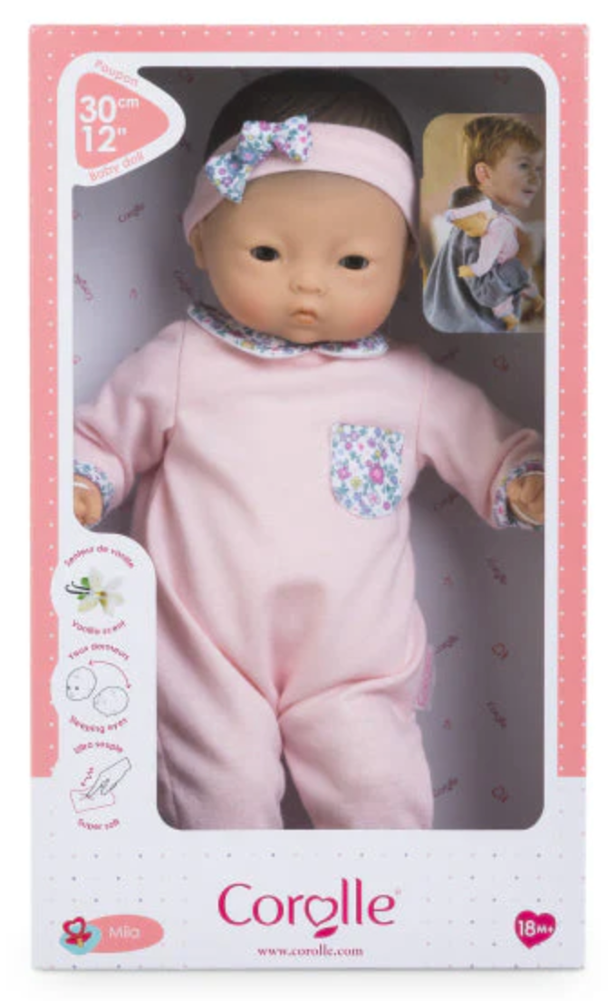 Calin Mila baby doll in pink floral outfit with headband, poseable body, and vanilla scent in branded Corolle box.