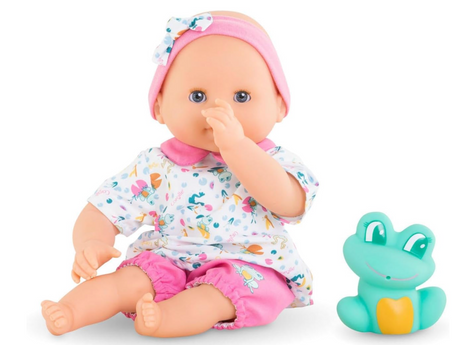 Bath Baby Oceane doll in a floral outfit with pink accents sitting next to a blue frog bath toy.