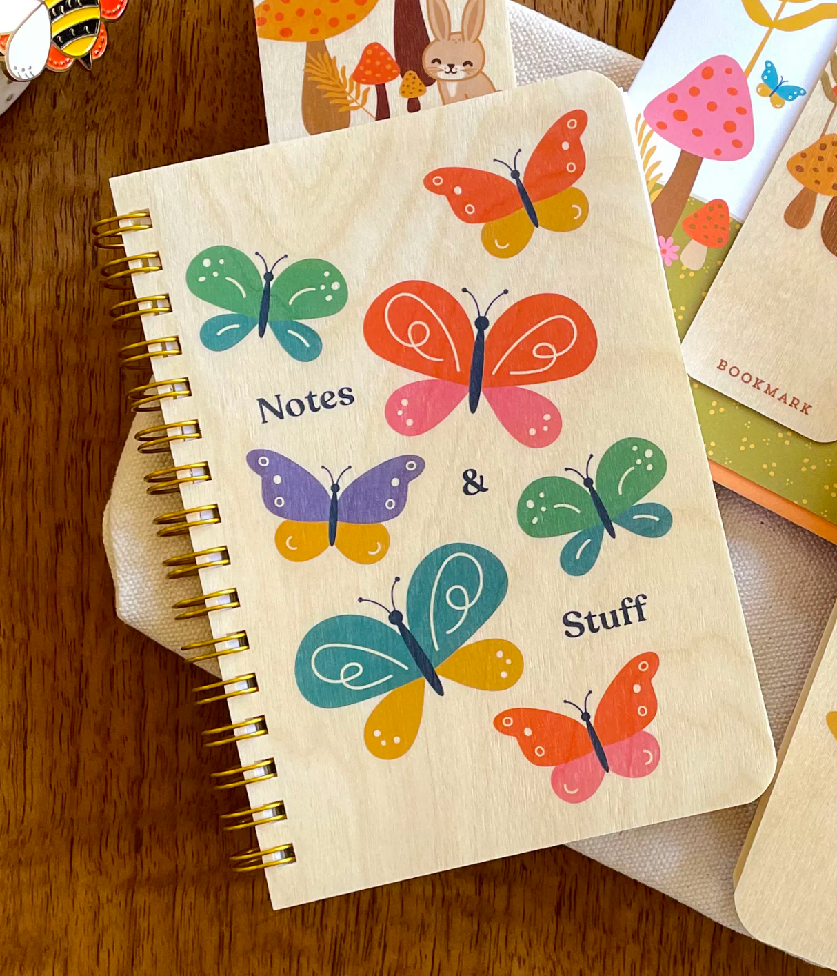 Wood Notebook | Butterfly Notes with colorful butterfly design on eco-friendly birch wood cover and gold spiral binding.
