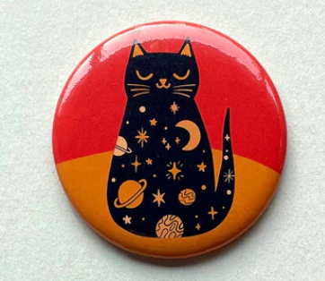 Cosmic Kitty Magnet featuring a black cat with space-themed designs on a red and orange background, 2.25-inch round.